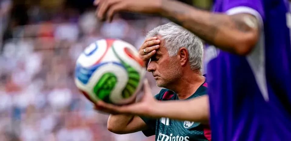 Manager with hand on forehead during match