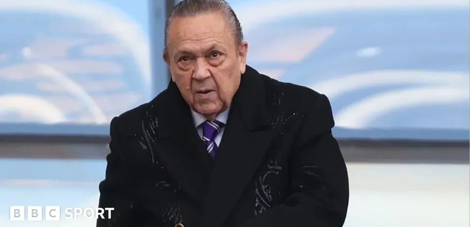 Man in formal attire at a sports event