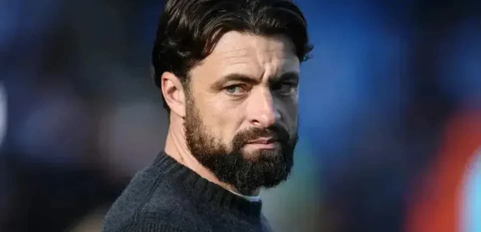 Man with beard looking away from camera