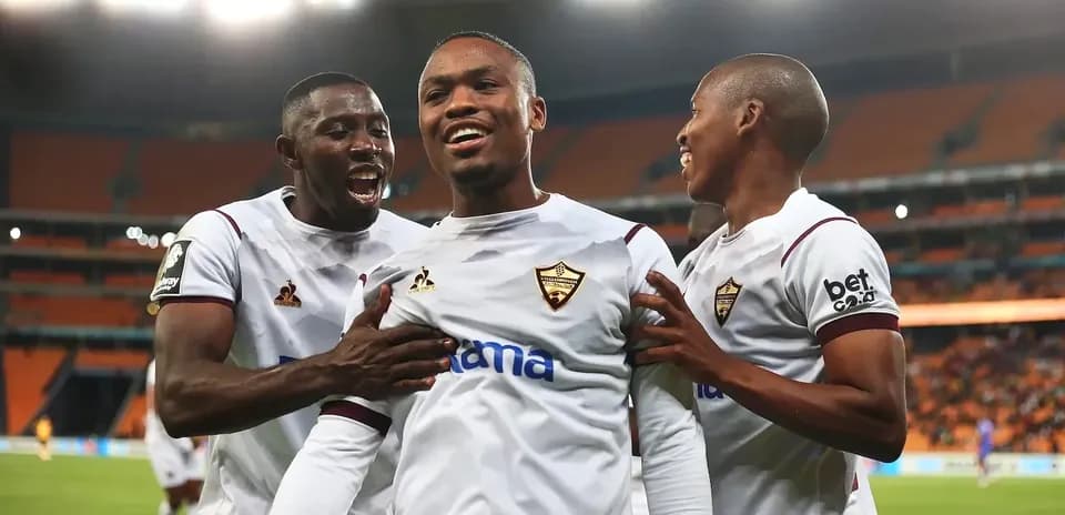 Players celebrating a goal on the field