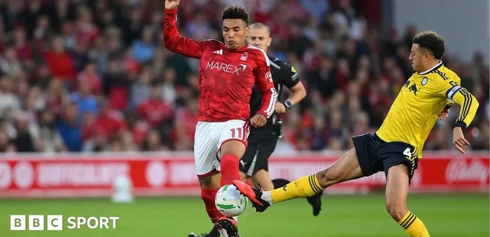 Player in red evading tackle from player in yellow