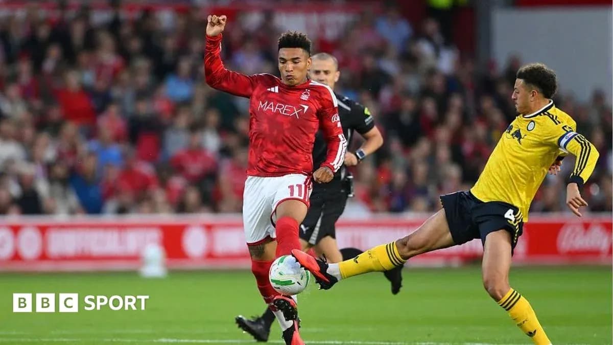 Player in red evading tackle from player in yellow