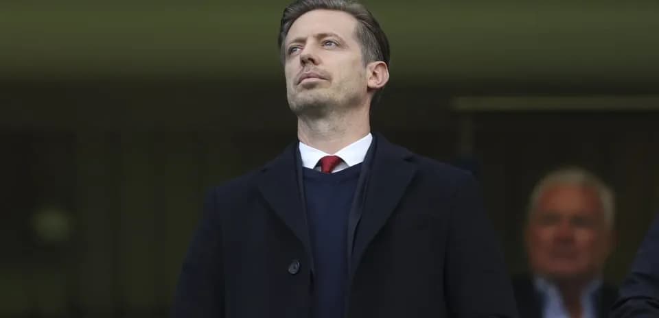 Man in suit observing from the stands
