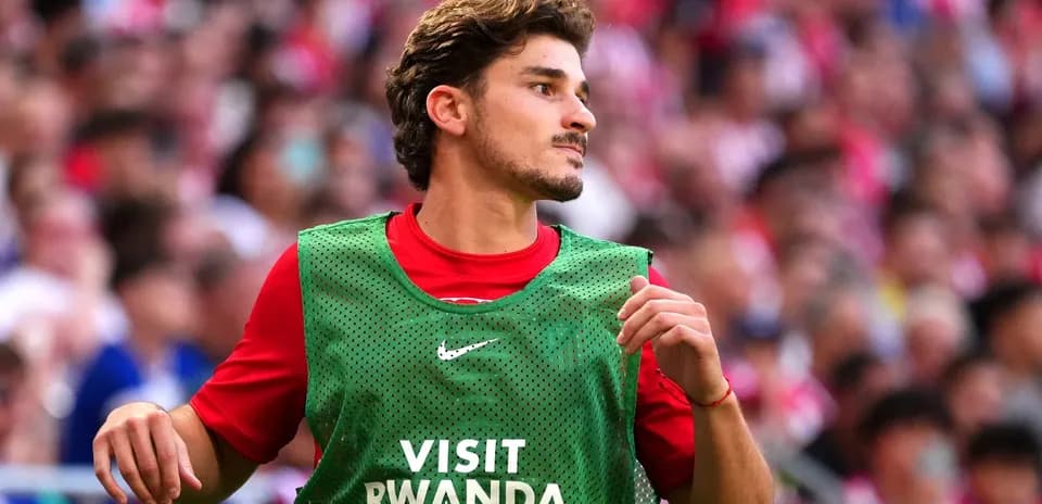 Player warming up on the sidelines in training bib