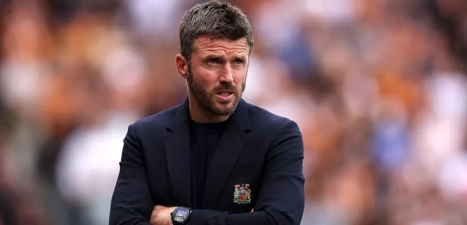 Manager with arms crossed during match