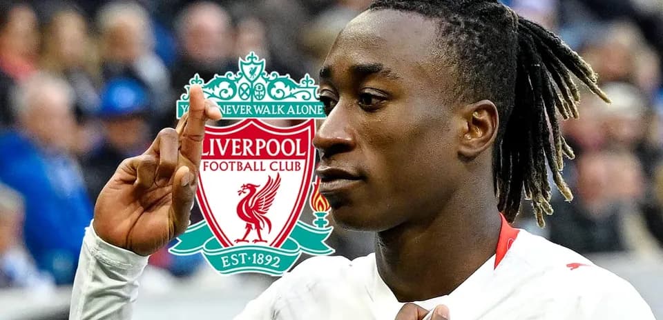 Player celebrating in front of Liverpool FC logo