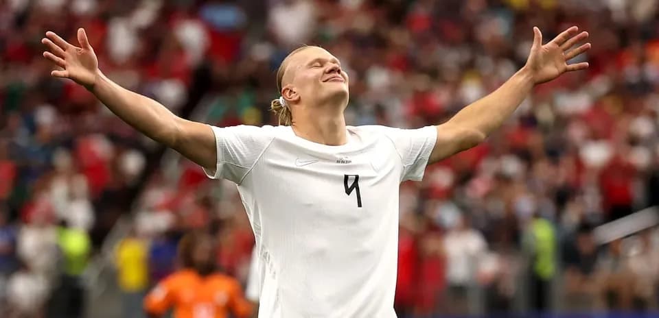 Player celebrating with arms raised on the field