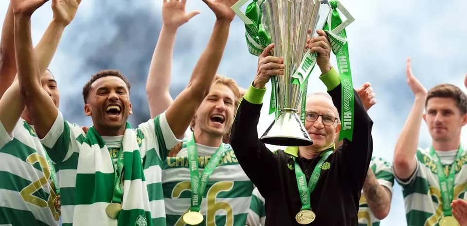 Celtic players celebrating trophy victory on stage