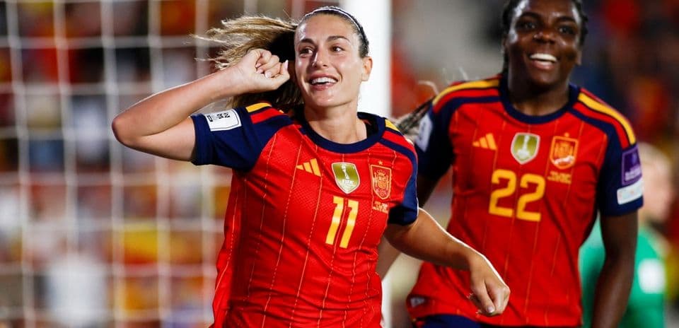 Spanish player celebrating a goal with teammate