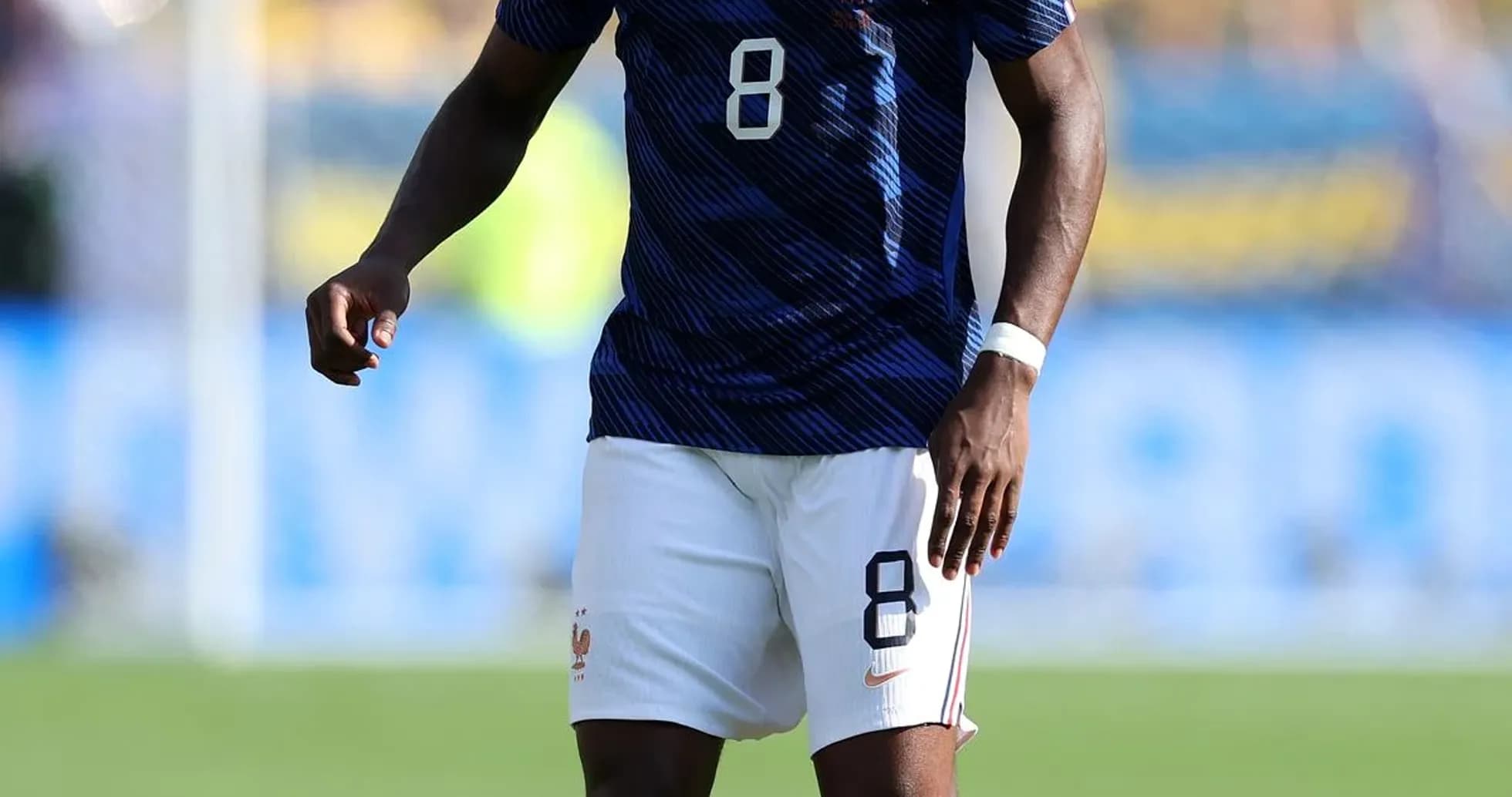 Player in France kit with ball on pitch