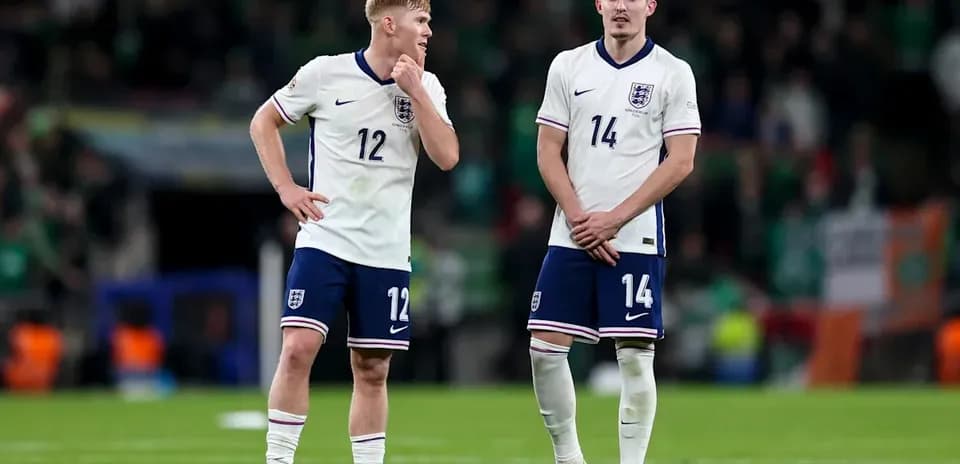 Two England players standing on the field after match