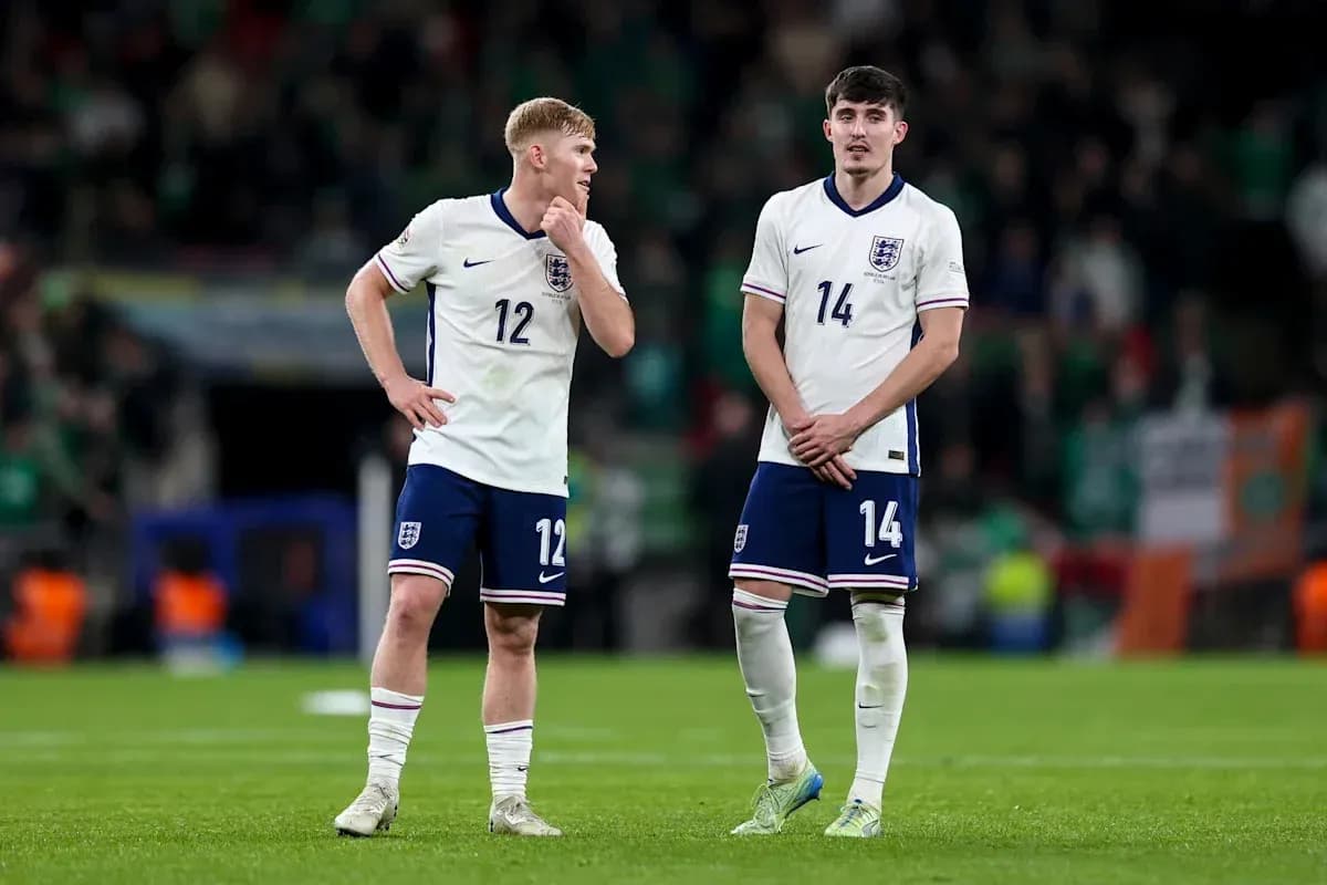Two England players standing on the field after match