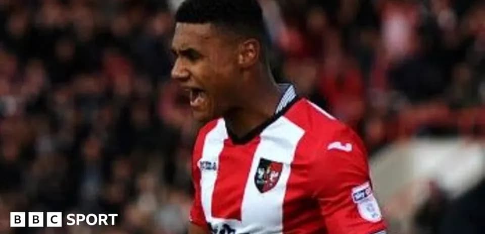 Player celebrating a goal in red and white jersey