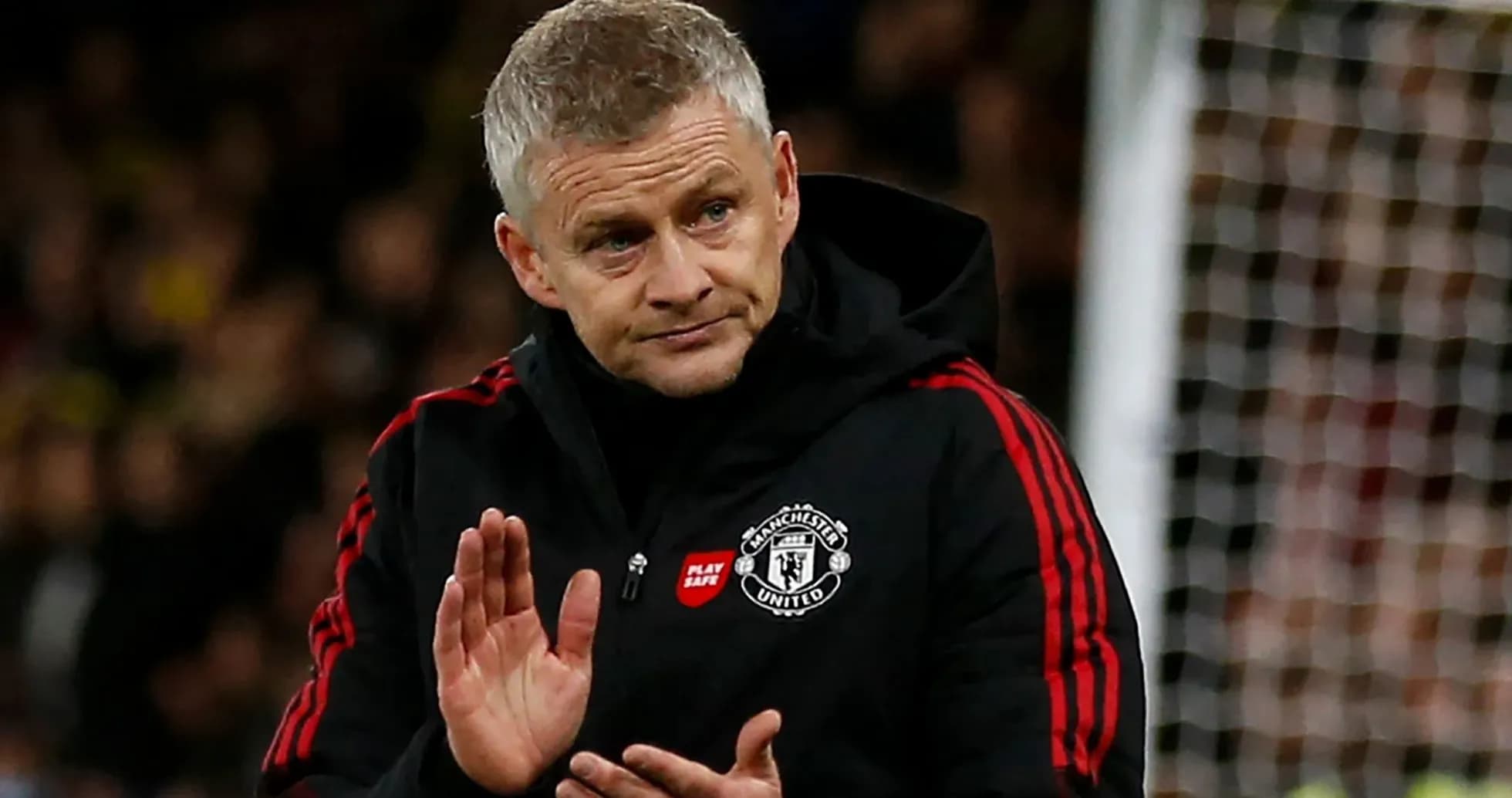 Manager applauding fans during a match