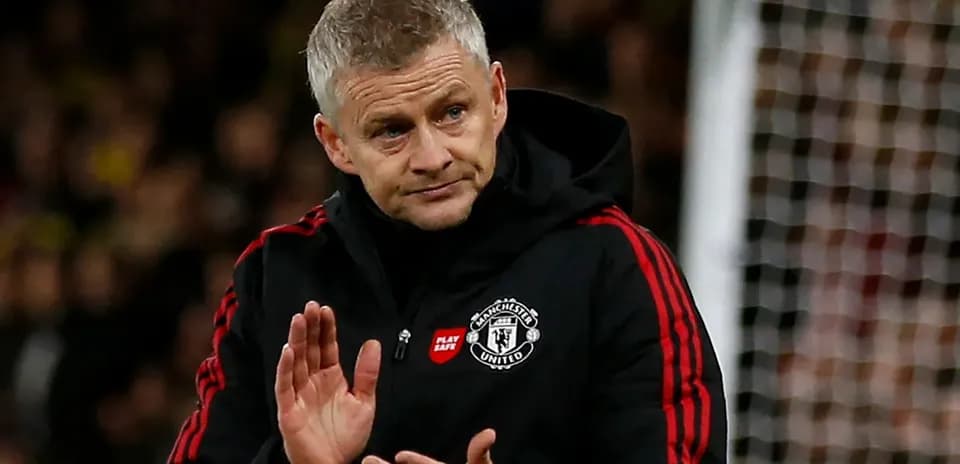 Manager applauding fans during a match