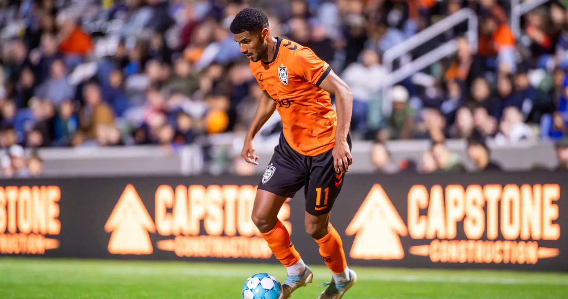 Player dribbling ball during Orange County SC match