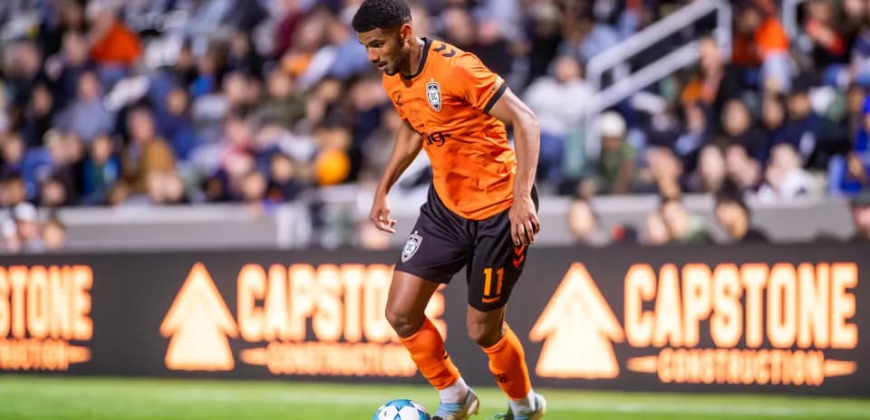 Player dribbling ball during Orange County SC match