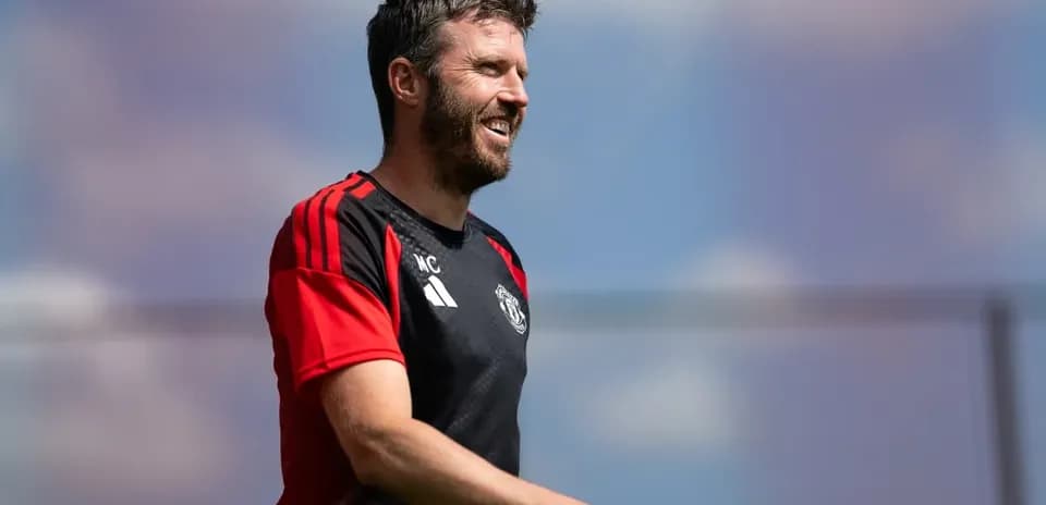 Coach smiling during training session at Manchester United