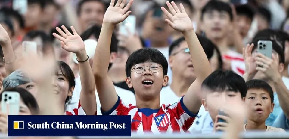 Young fan cheering in Atletico Madrid jersey