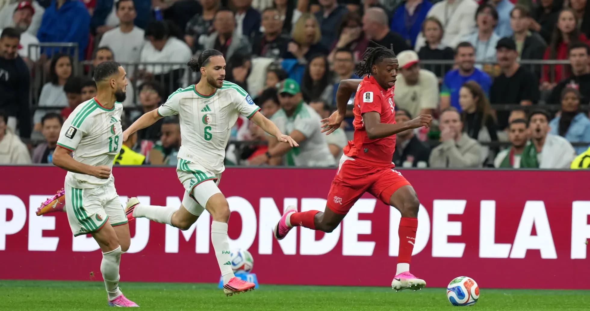 Players from Switzerland and Algeria competing for the ball