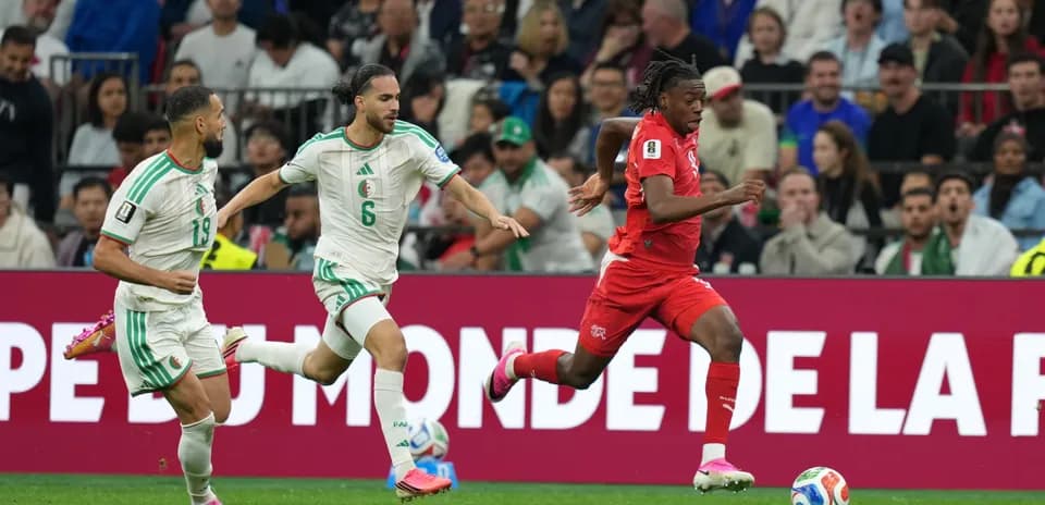 Players from Switzerland and Algeria competing for the ball