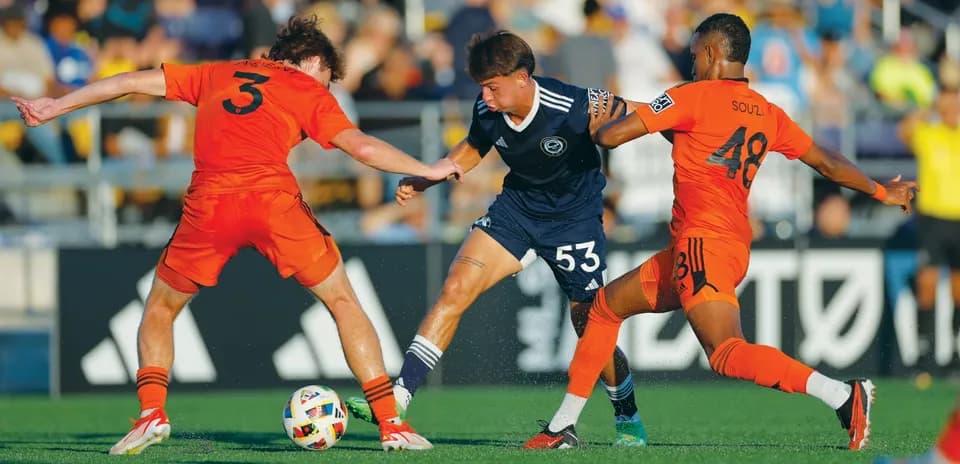Players competing for the ball during match