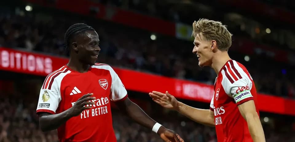 Two Arsenal players celebrating during a match