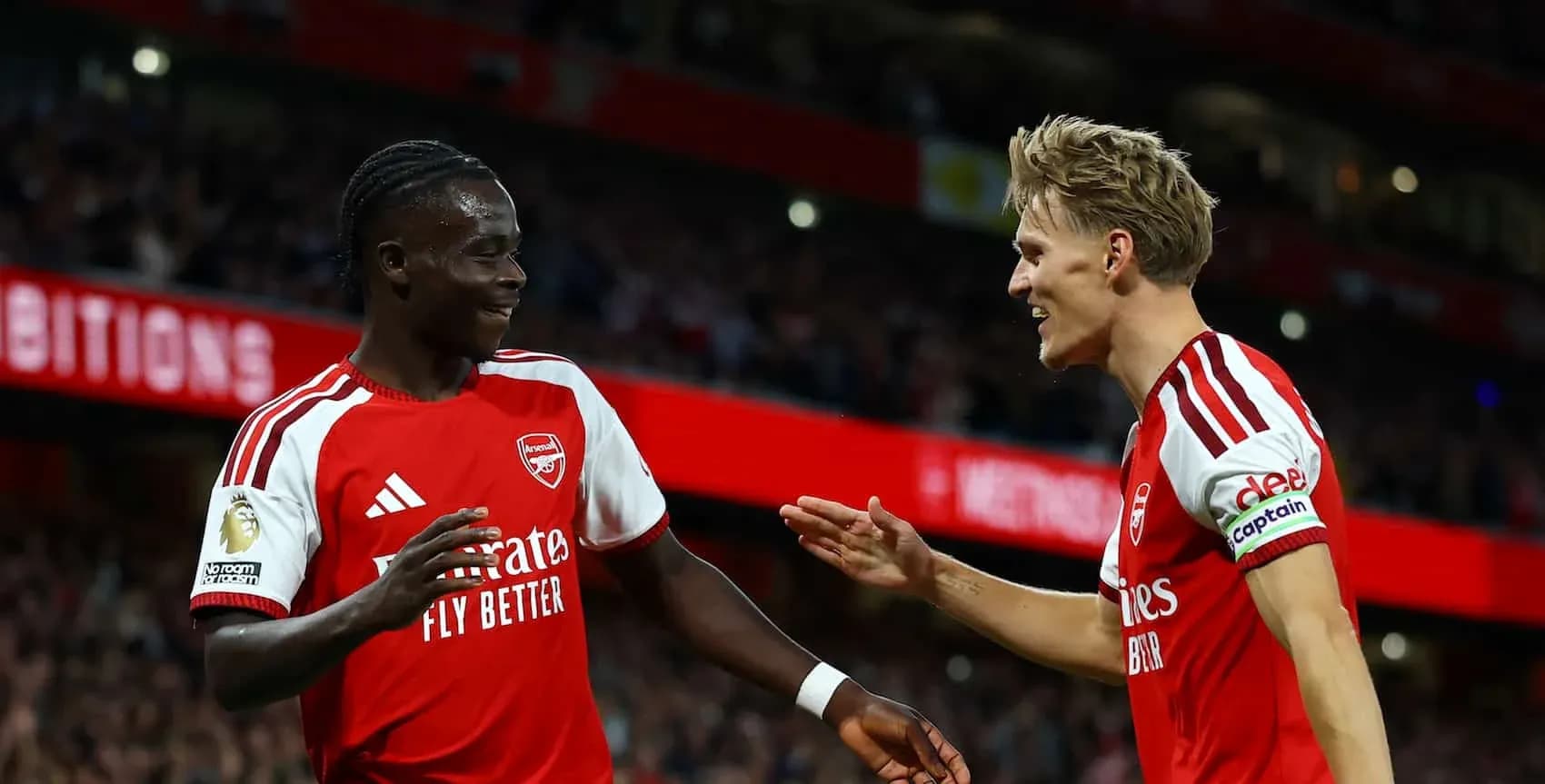 Two Arsenal players celebrating during a match