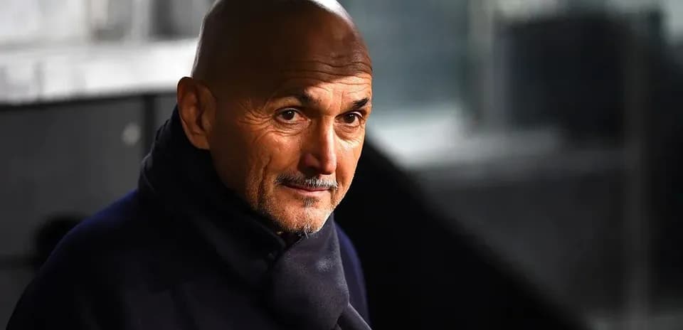 Coach wearing a dark scarf in stadium