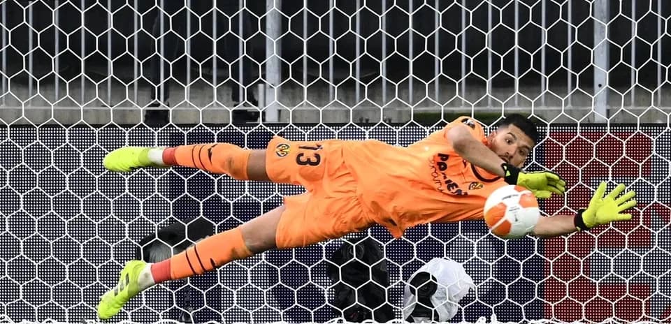 Goalkeeper diving to save a penalty kick