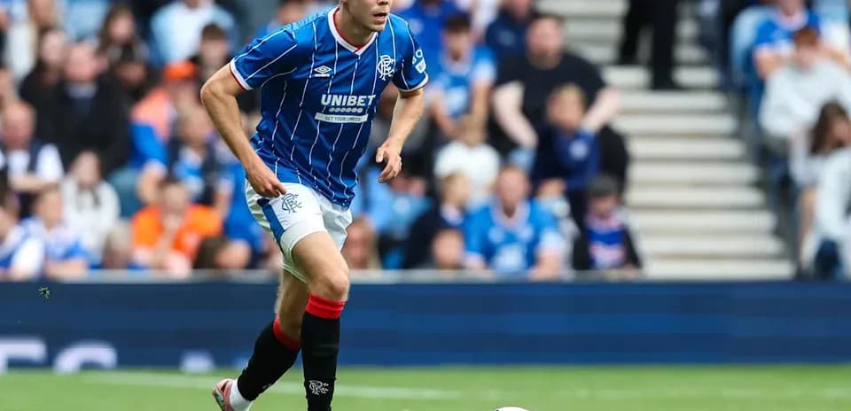 Player in blue kit running with soccer ball