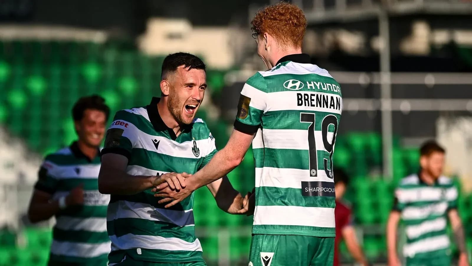 Two players celebrating a goal on the field