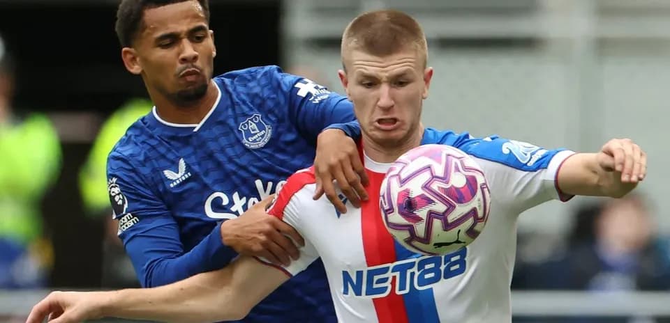 Two players contesting for the ball during match