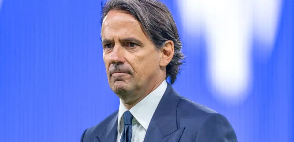 Coach standing during a press conference backdrop