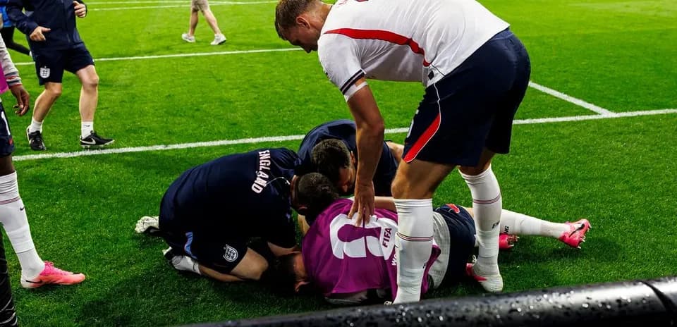 Players attending to an injured teammate on field