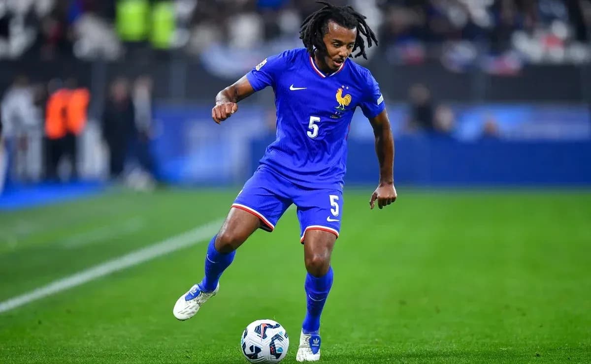 Player in blue kit dribbling soccer ball on field