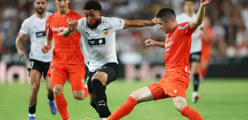 Players contesting the ball during La Liga match