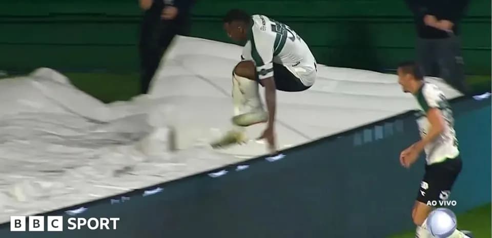 Player jumping over a tarpaulin during match