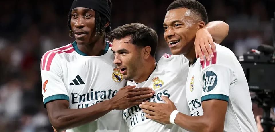 Three Real Madrid players celebrating a goal together