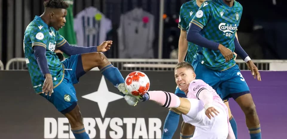 Player challenges goalkeeper for the ball