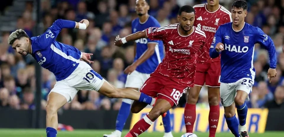 Ipswich player tackles Liverpool defender during match