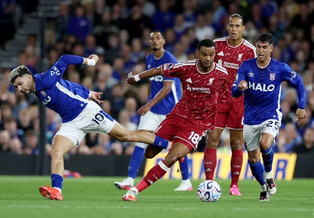 Ipswich player tackles Liverpool defender during match