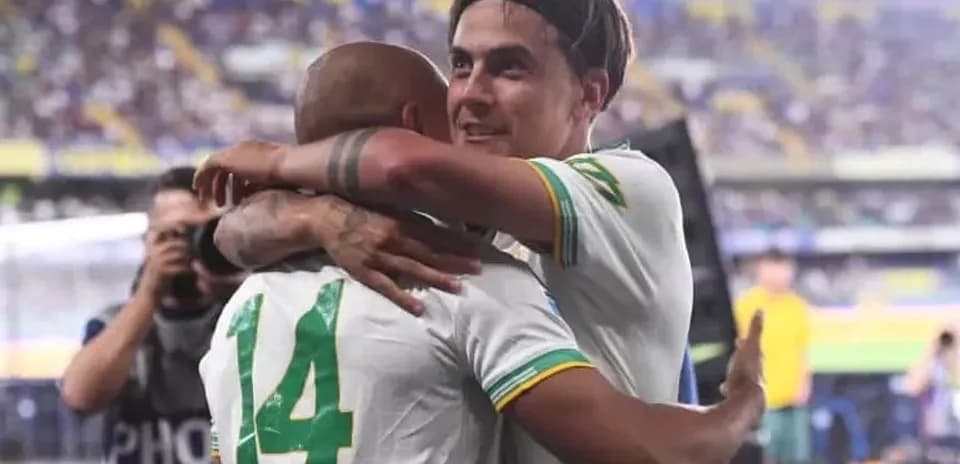 Two players celebrating with an embrace on the field