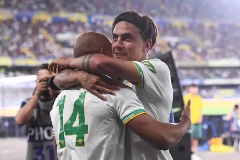 Two players celebrating with an embrace on the field
