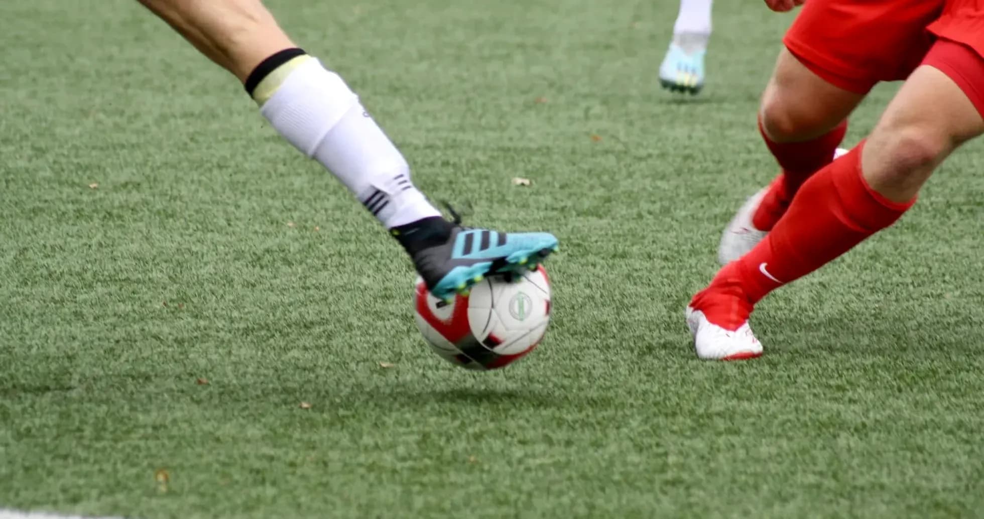 Players competing for the ball in football match
