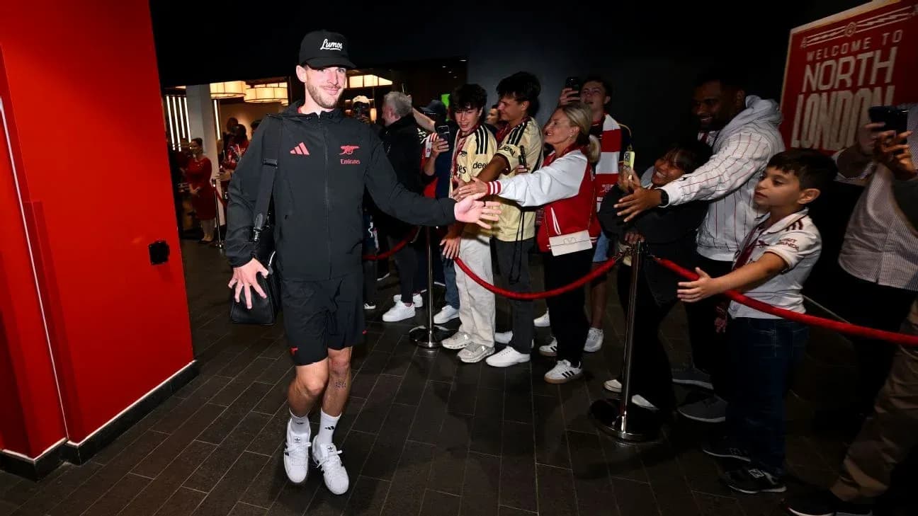 Player greeting fans upon arrival at stadium