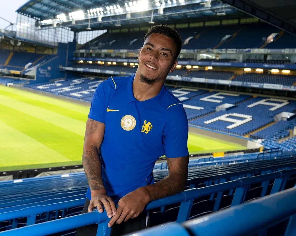 Player posing in Chelsea stadium stands
