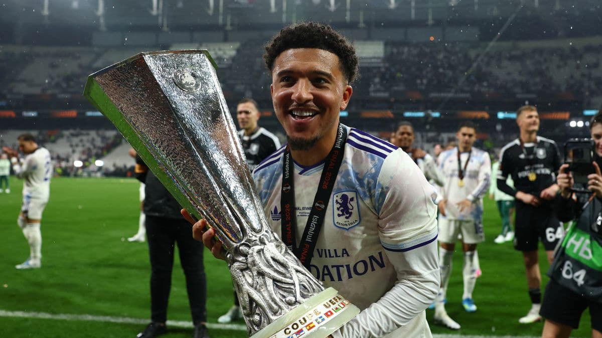 Player celebrating with UEFA trophy on field