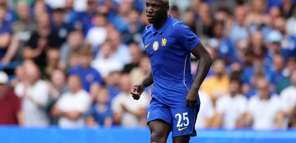 Player wearing Chelsea kit during match on field