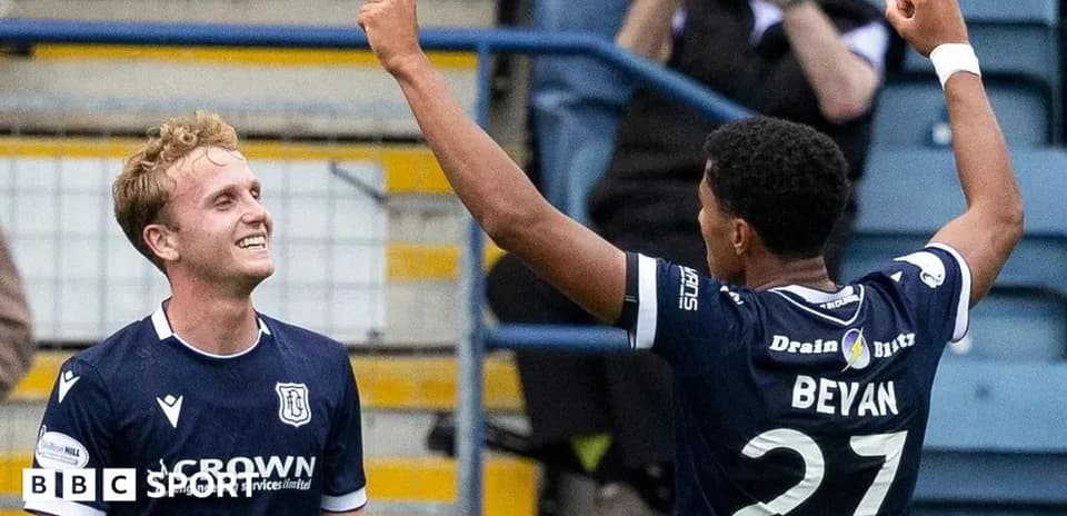 Two players celebrating a goal on the field